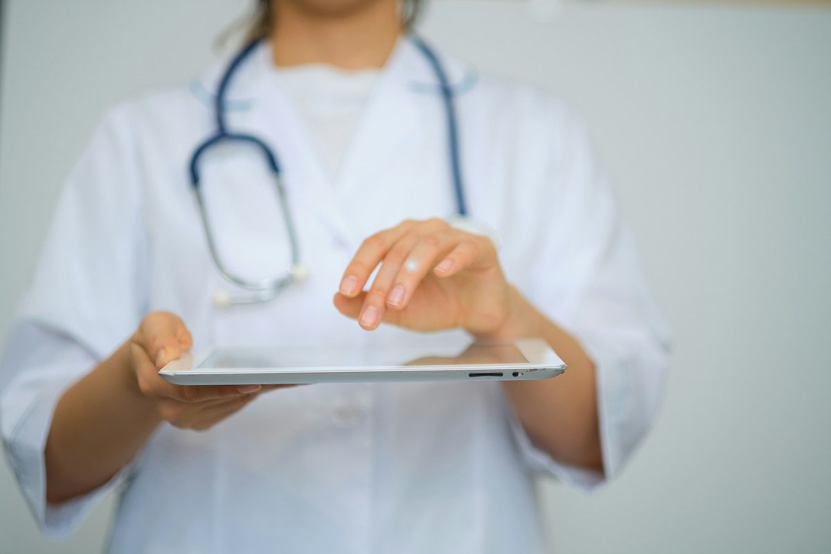 medicine, health and hospital concept close up of female doctor working with tablet pc.
